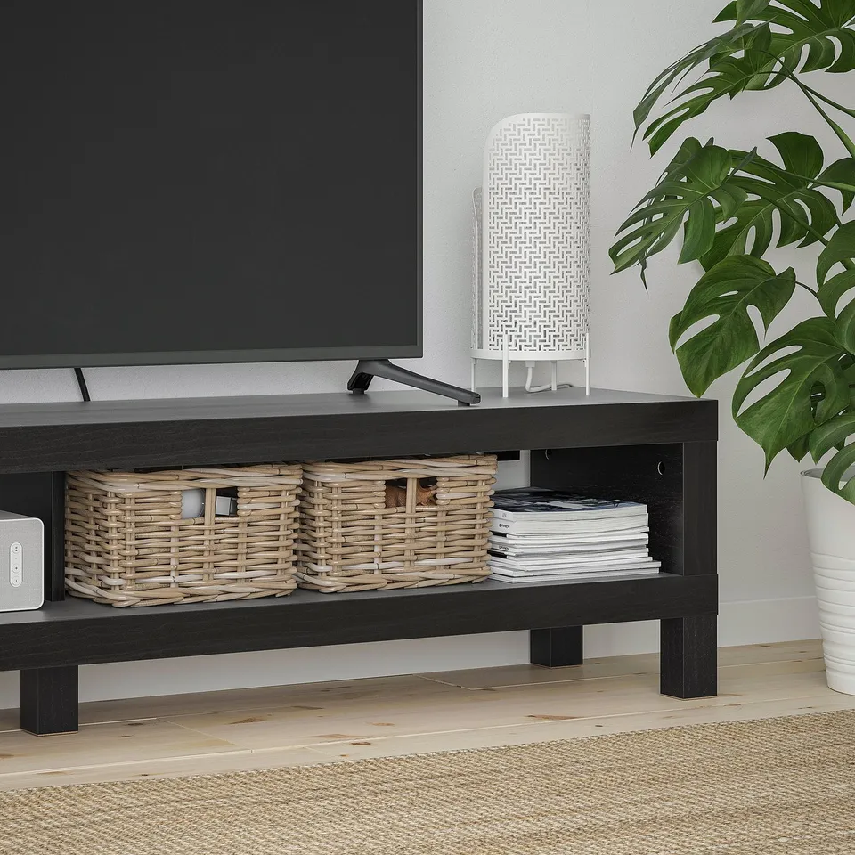BLACK tv stand with baskets, dvds, tv, plant.