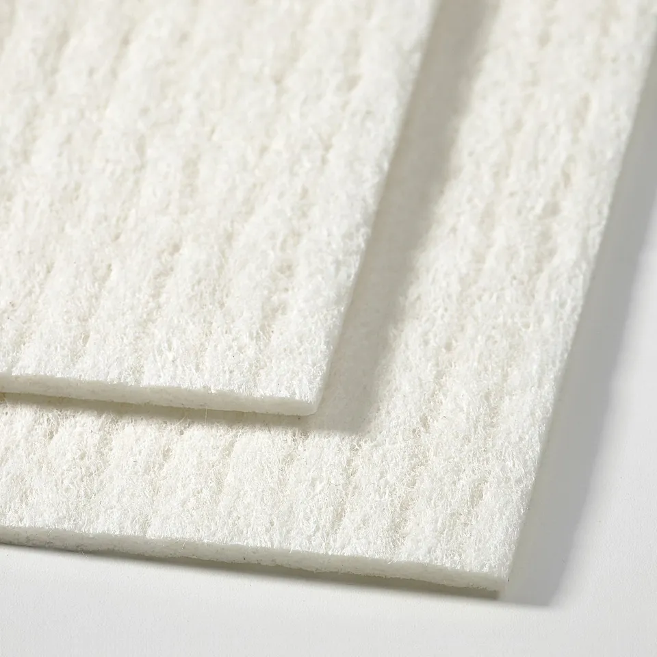 Stacked white cleaning cloths, soft texture, neatly arranged.