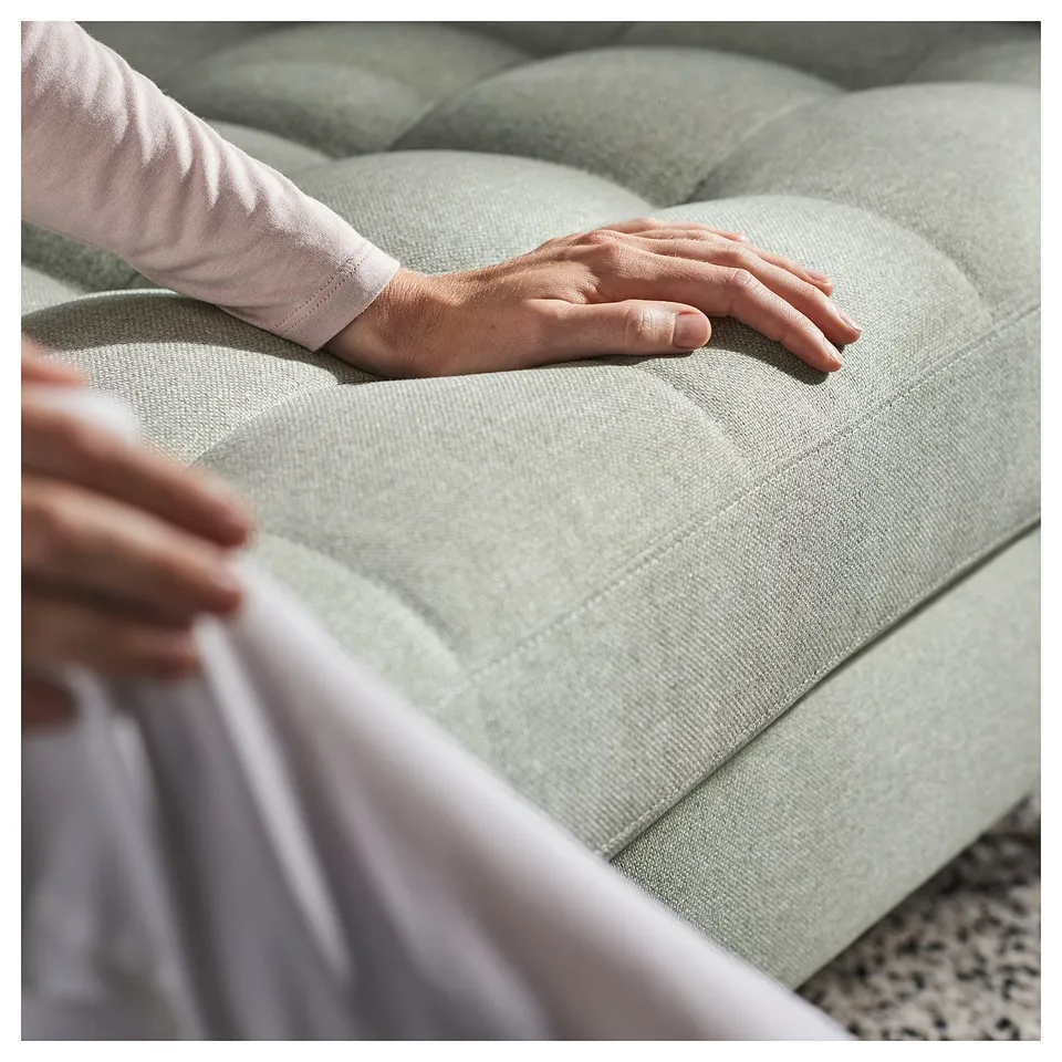 Hands on grey couch, showcasing LANDSKRONA sofas soft fabric and comfortable look.