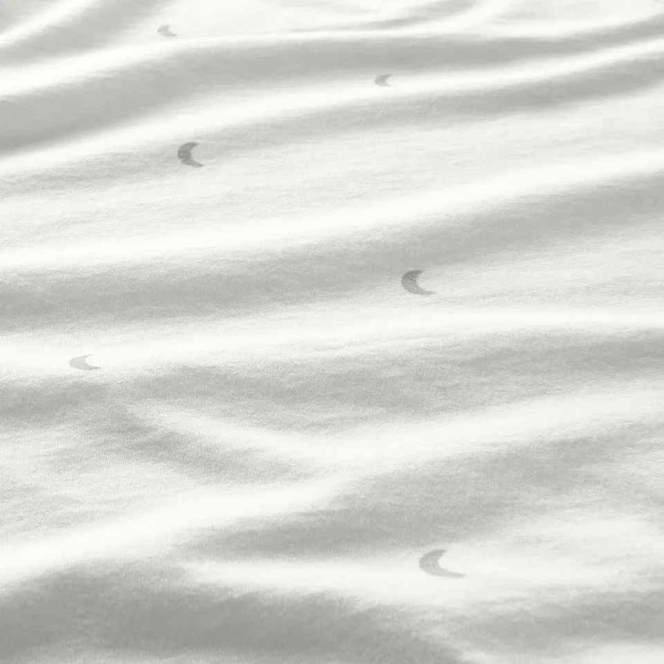 Soft, monochrome jersey fabric closeup with gentle folds, showcasing smooth texture.