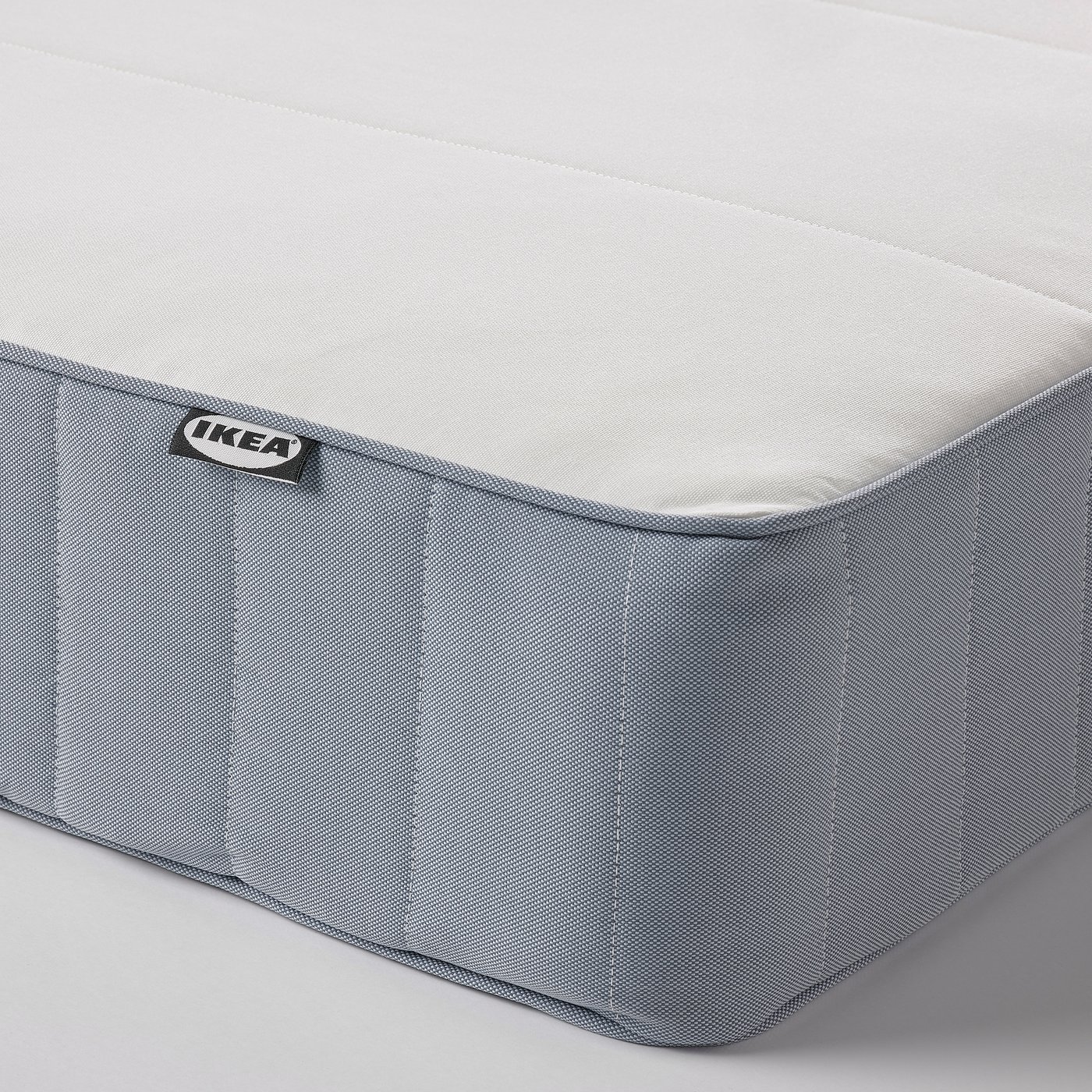 Ikea mattress corner close-up, showing quality fabric and logo.