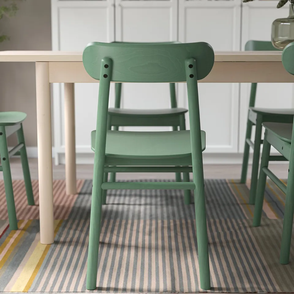 Stylish green chair at modern table, ideal for small spaces. Part of a LISABO 2-seat dining set.