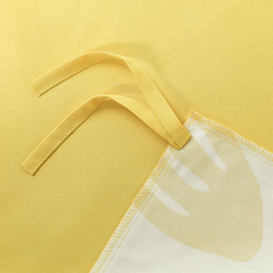 Yellow bedding with ties, featuring half-circle design and white stitching.