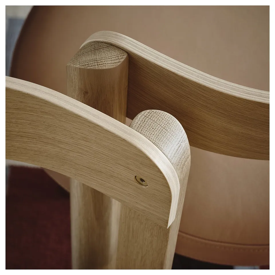 Close-up of oak chair joint; smooth, high-quality wood finish and sturdy craftsmanship.