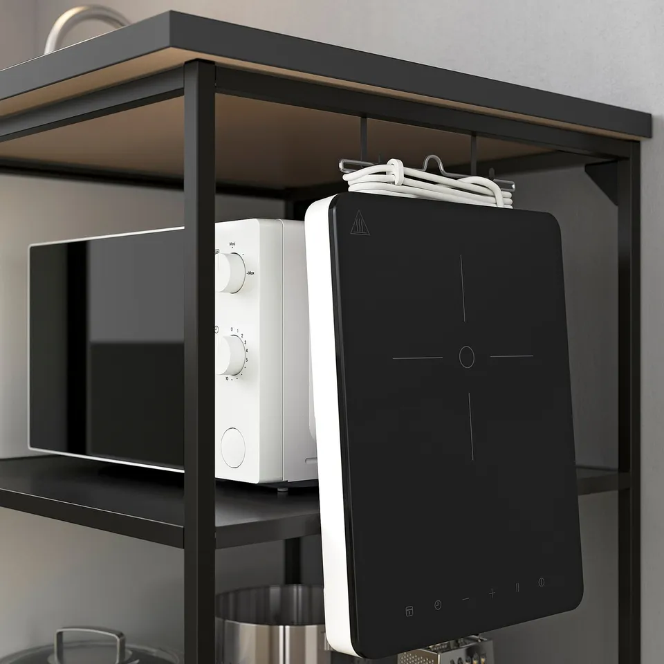 Black kitchen shelf displaying a microwave and black-and-white device.
