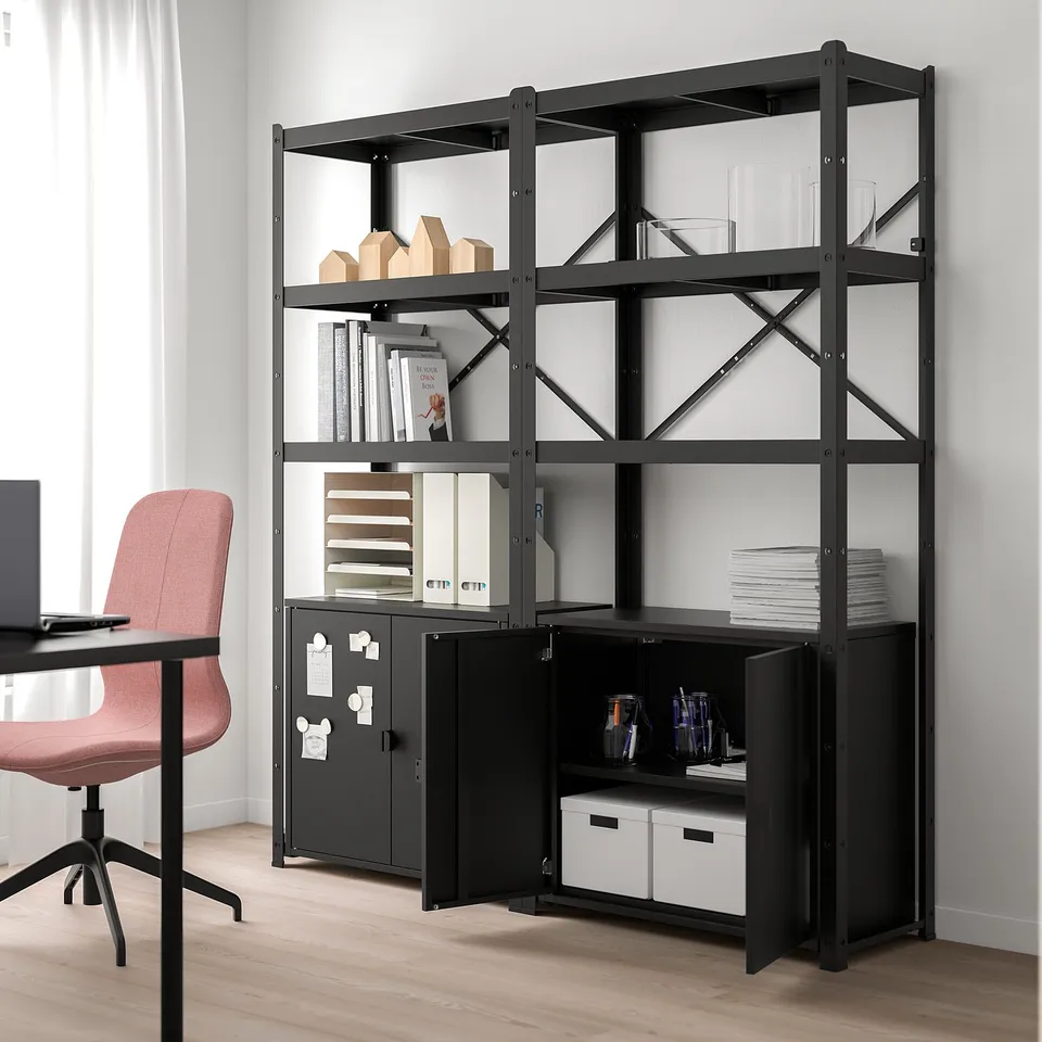 Black BROR storage unit with open shelves & cabinets, large & industrial, near desk & chair.