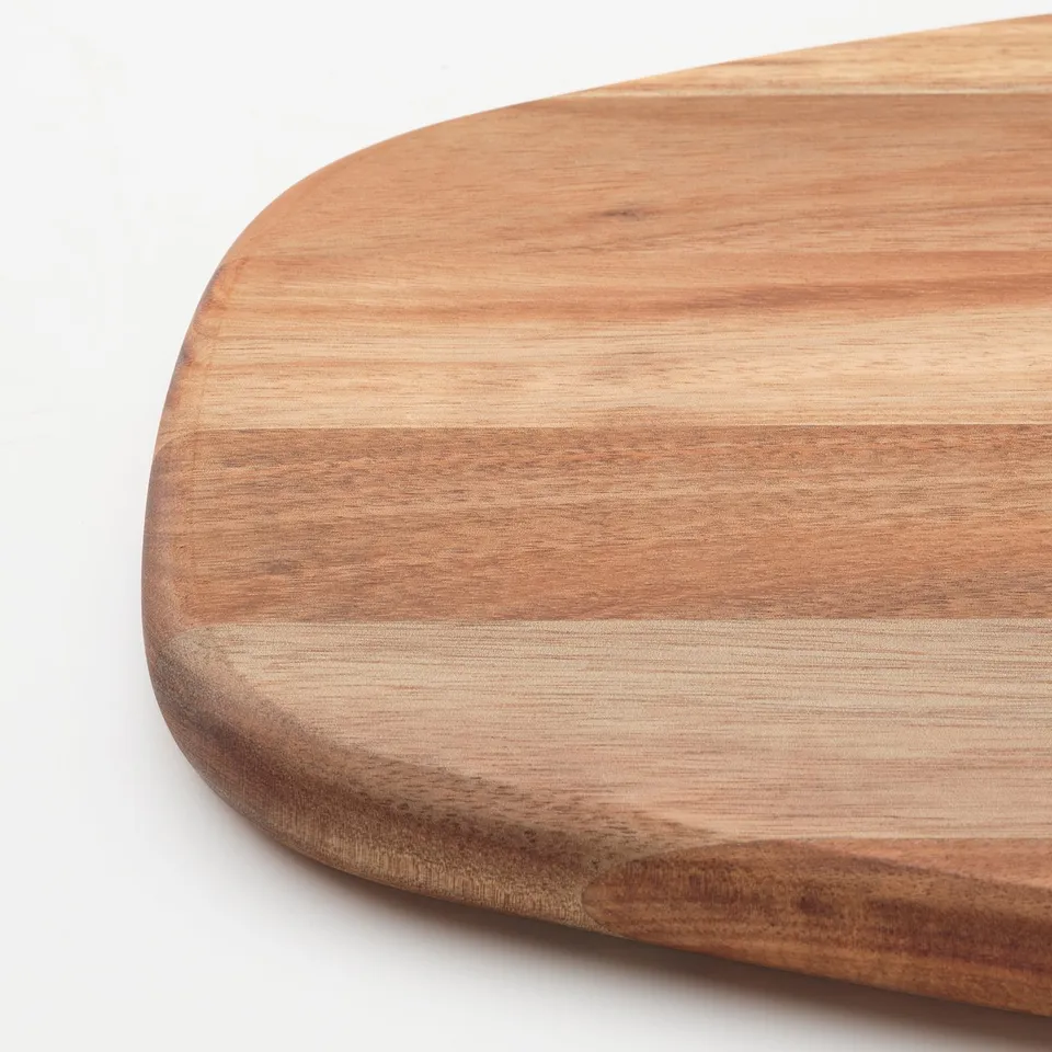 Round wooden cutting board, smooth finish, acacia wood, visible grain texture.