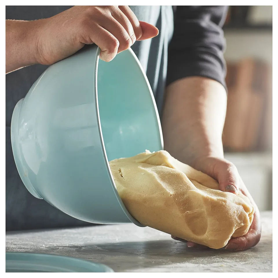 Person handling dough with light blue GARNITYREN bowl.
