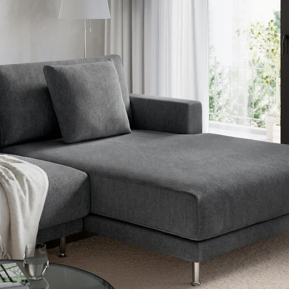 A modern, grey fabric sectional sofa with a chaise lounge, designed for comfort and relaxation.