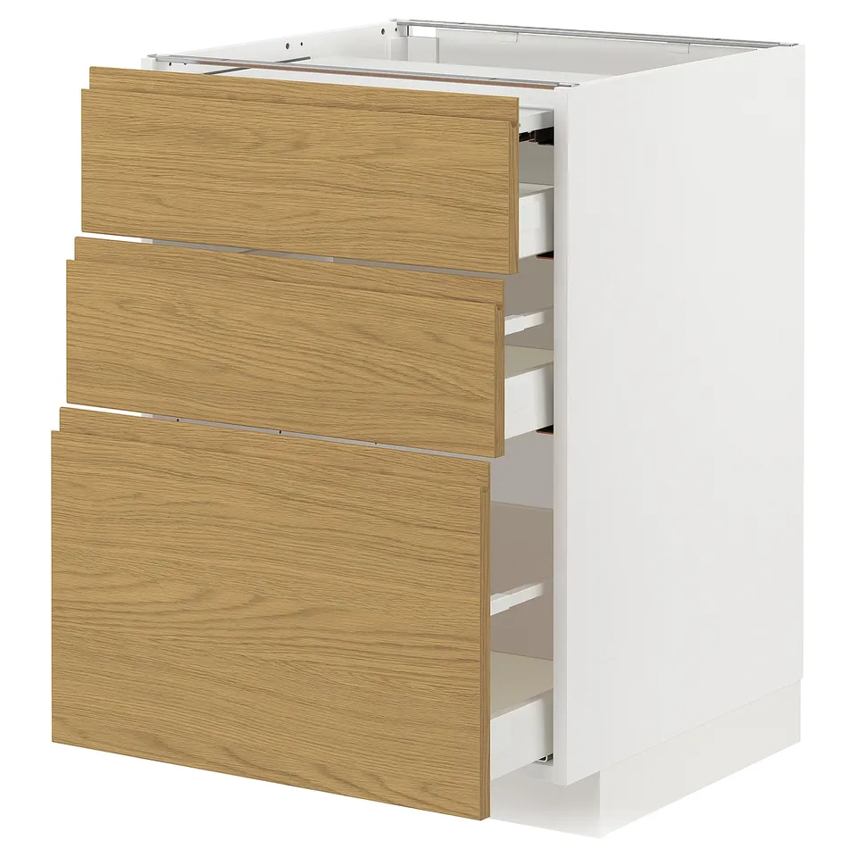 A white METOD kitchen cabinet with oak-colored wood grain drawers. It three open drawers revealing internal organisers.