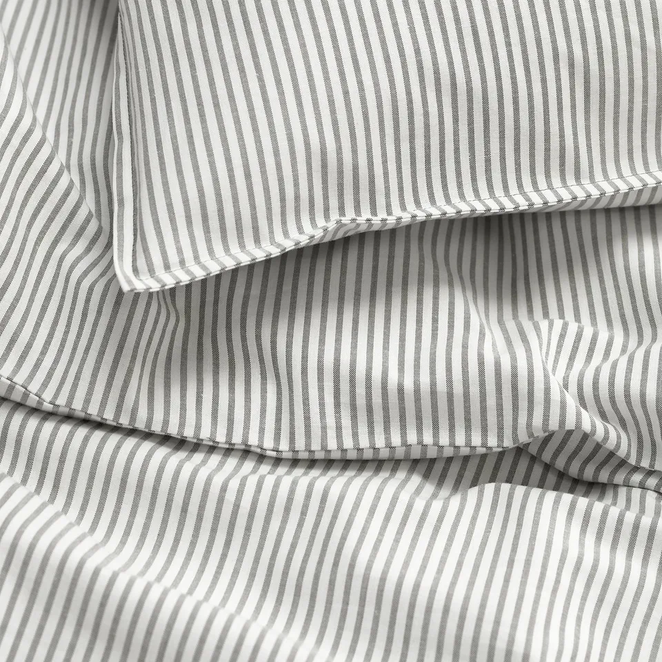 Black and white striped fabric close-up, showing texture and stitching detail.