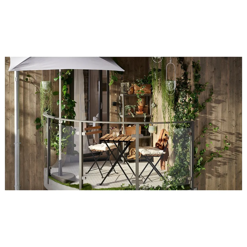 Small outdoor table and chair set, rustic with acacia wood and black steel, perfect for balconies, folds flat.
