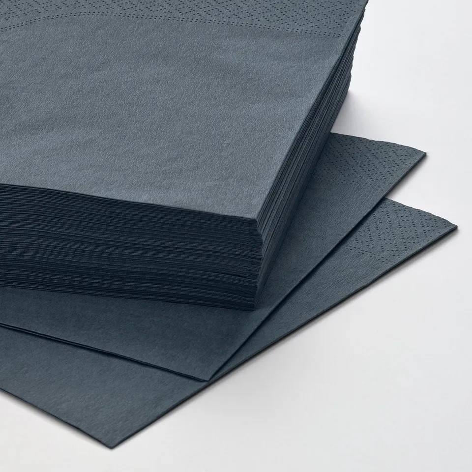 Stacks of dark blue napkins arranged neatly. Top one folded back to reveal more layers.