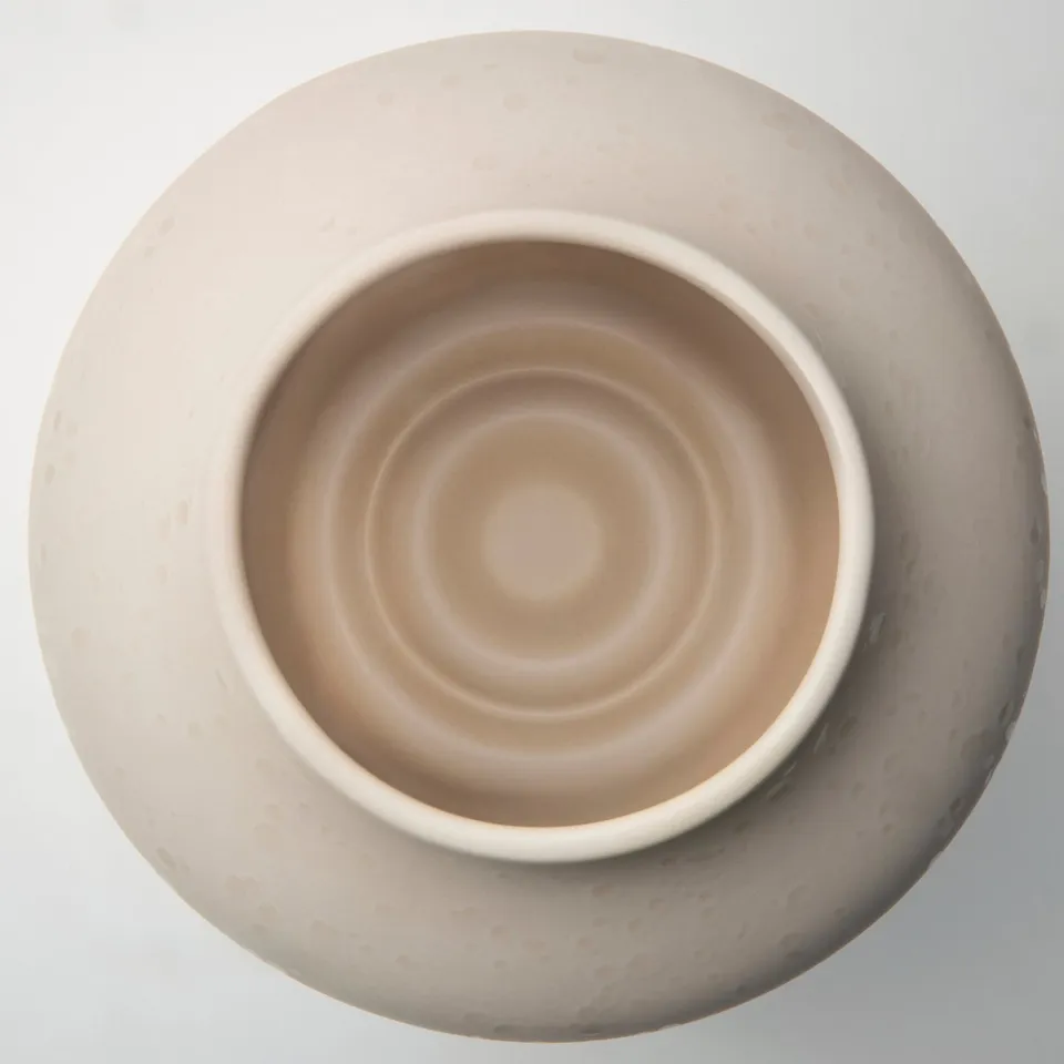 Elegant matte stoneware vase with hand-splashed dots, wide opening, and ring base, perfect for displaying flowers.