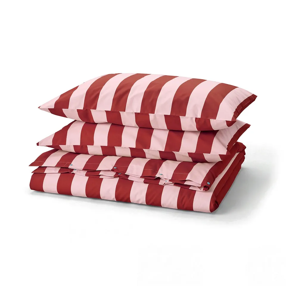 Folded red and white striped bedding set; duvet cover and pillowcases, in cotton and lyocell blend.