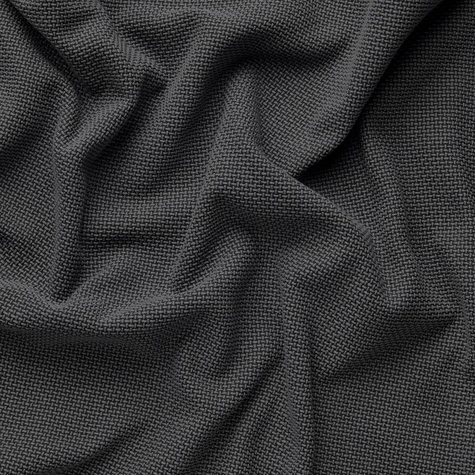 Close-up of dark, woven fabric, showcasing its sturdy texture and subtle pattern.