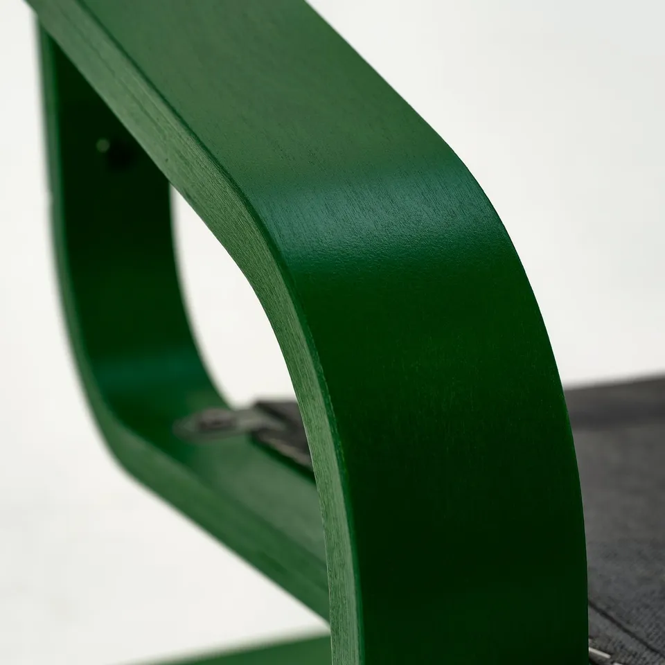 Bright green, modern chair part with smooth, curved edges, showcasing high quality craftsmanship.