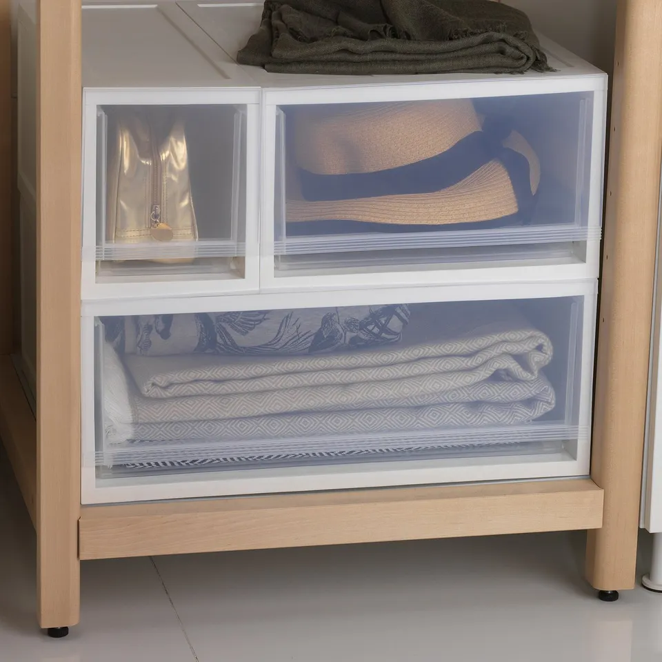 White SOPPROT storage drawers stacked with textured fabrics inside, showcasing organised and accessible storage.