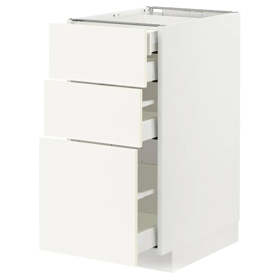 White METOD kitchen cabinet with three open drawers, sleek modern design.