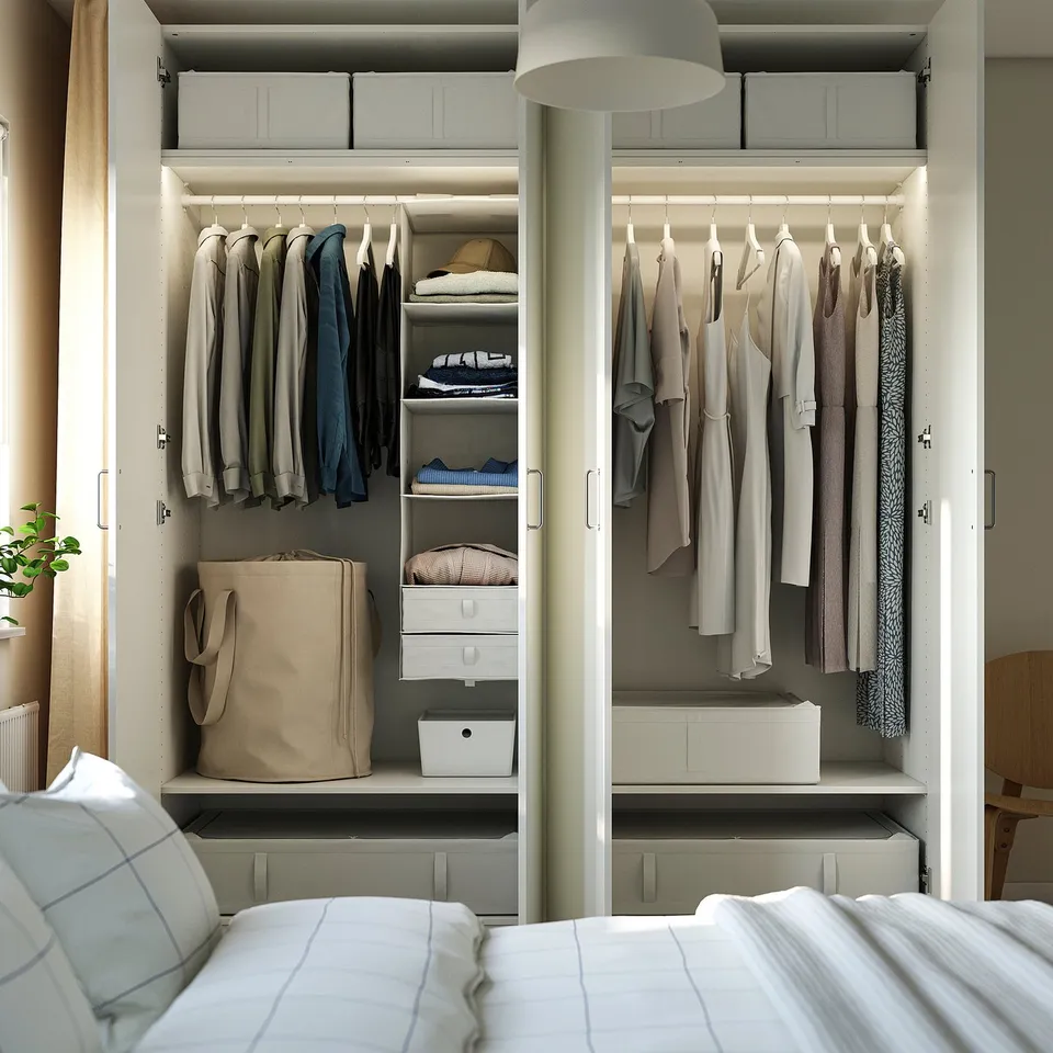 Open closet with clothes, shelves, and storage boxes.