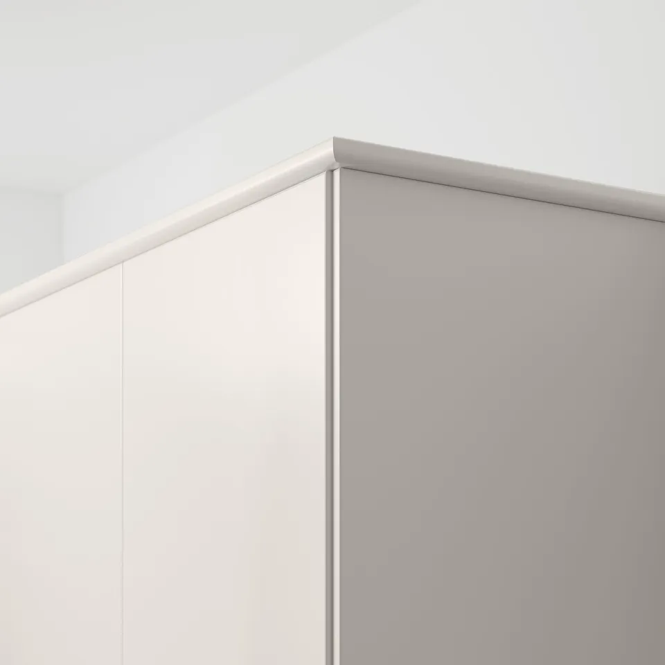 White kitchen corner trim, attaches under cabinets to conceal lights and cords.