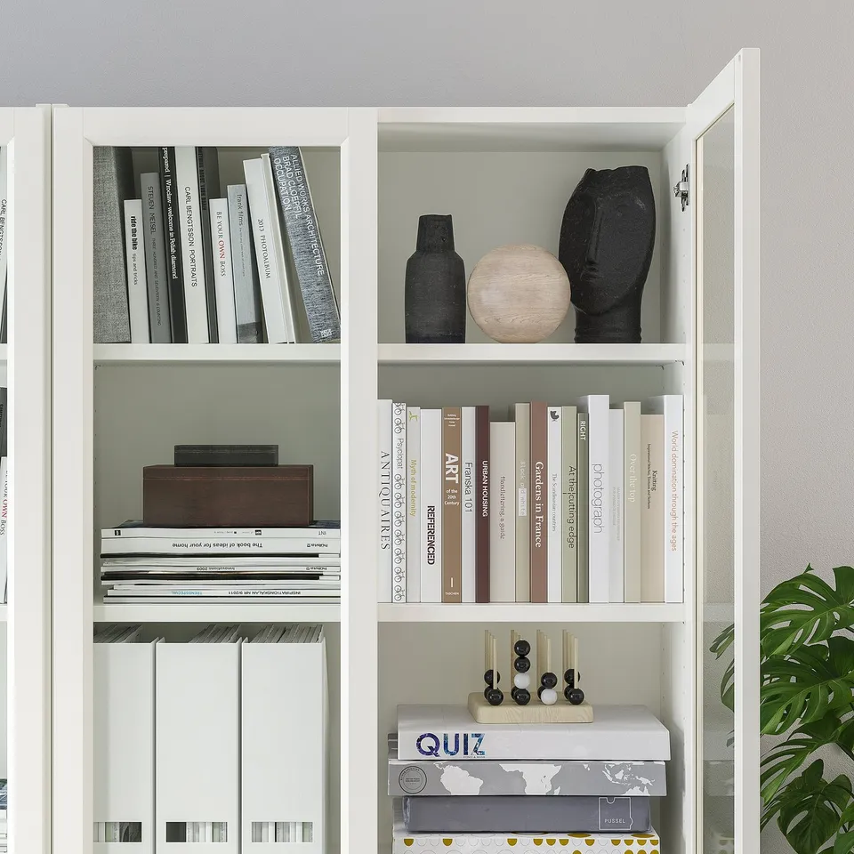 BILLY bookcase with glass doors, adjustable shelves for books, decor, and games.