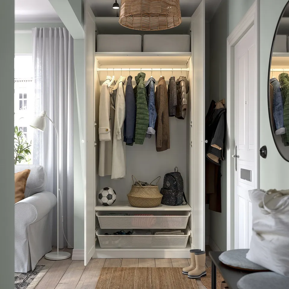 Well-organized closet with coats, shelves, and storage bins.