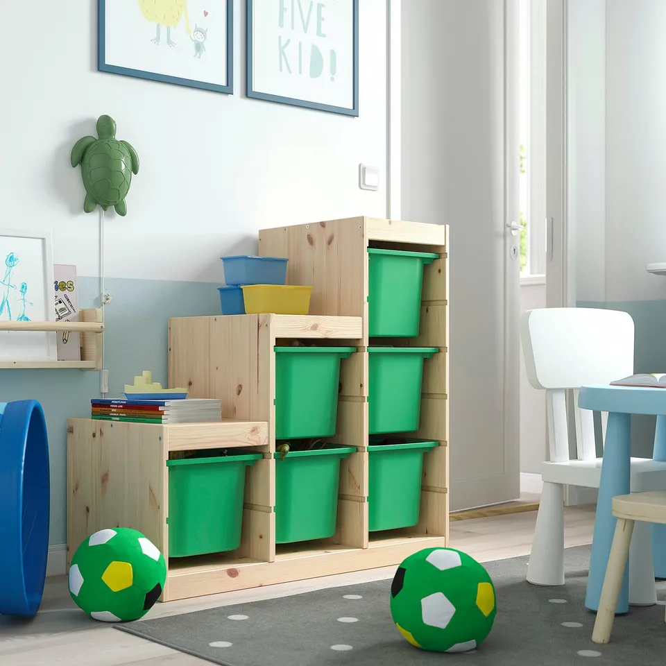 Kids room with TROFAST storage, light wood, green bins, toys, and decorations.