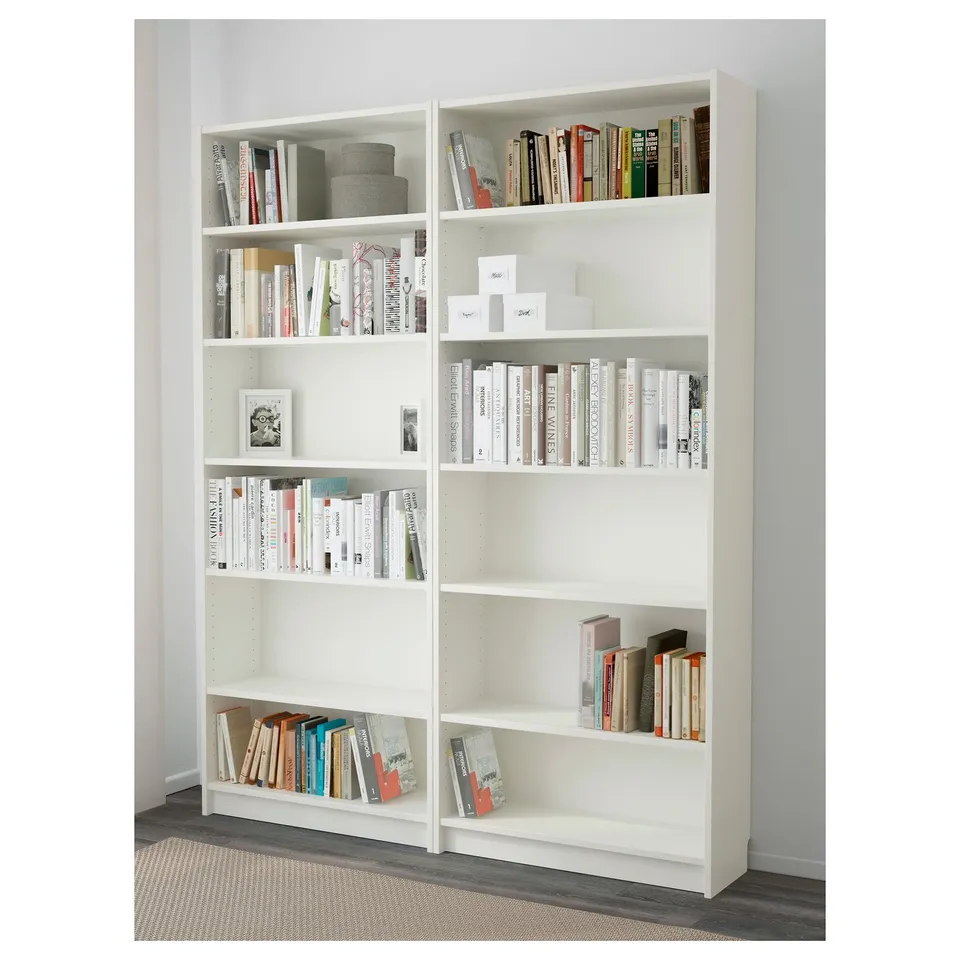 White BILLY bookshelf with multiple shelves holding assorted books and knick-knacks.