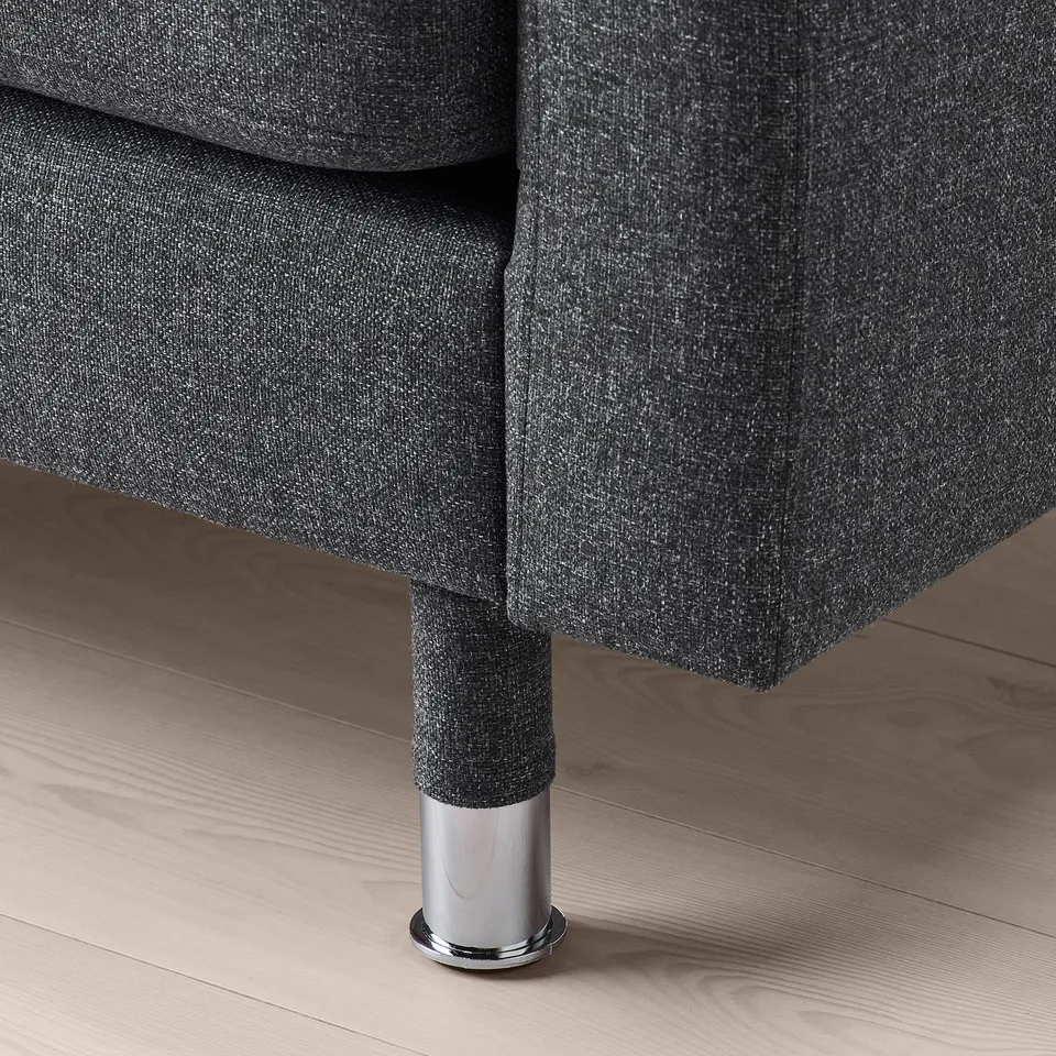Dark grey upholstered sofa leg with metal base.