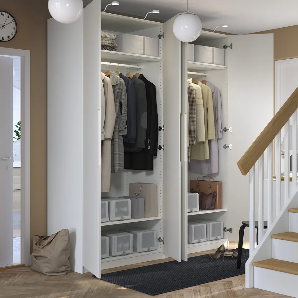 Organised closet with clothes, shelves, storage, lighting, dampers, near stairs.