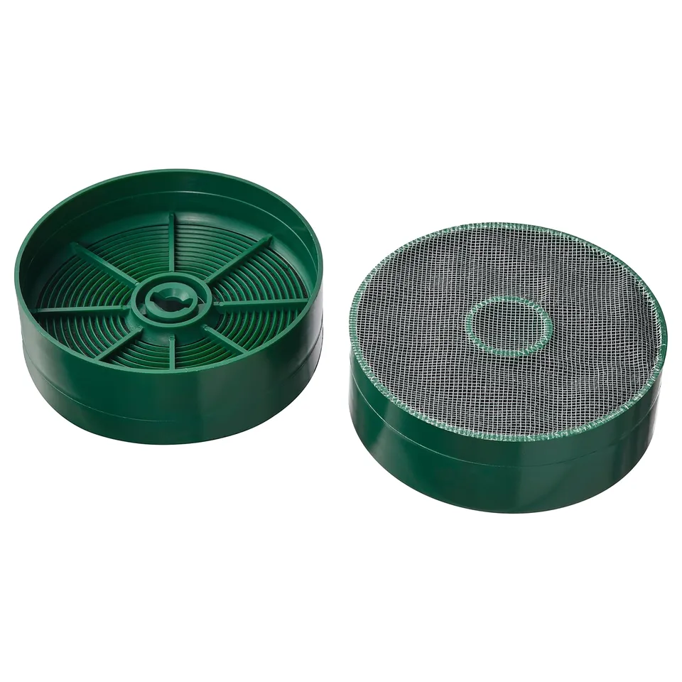 Two green circular charcoal philtres, one with carbon slats, one with mesh top.
