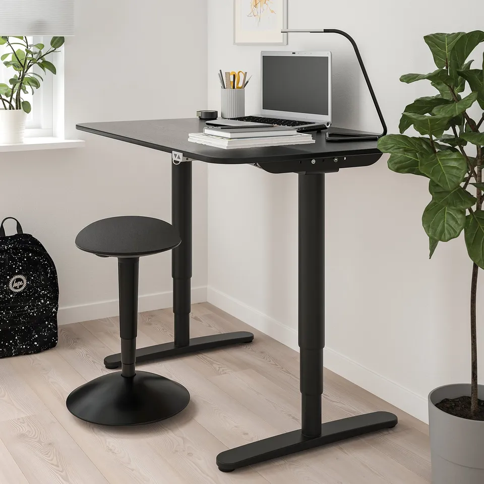 A NILSERIK stool with curved base and padded seat, designed for active sitting and workspace use.