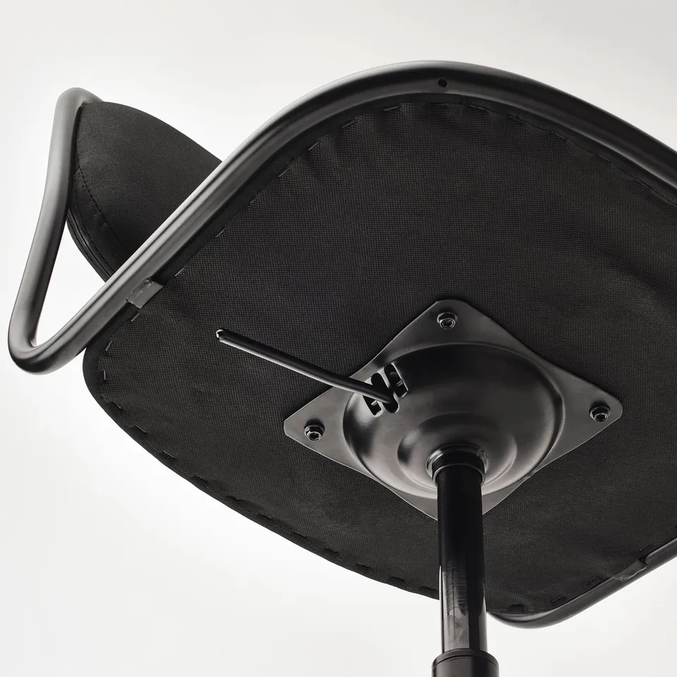 Close-up of modern swivel office chairs base, showing quality components: dense foam, sturdy steel, and smooth castors.