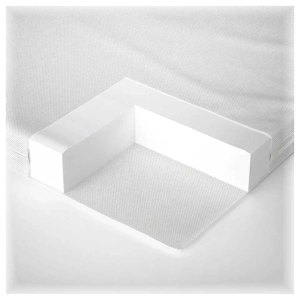 Minimalist white crib mattress with textured surface and supportive foam core.