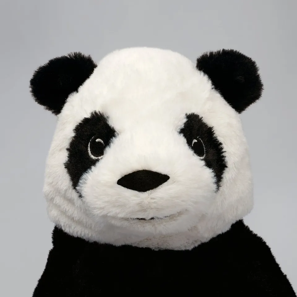 Cute plush panda toy, well-made with soft white and black fabric, detailed perfect for cuddling.