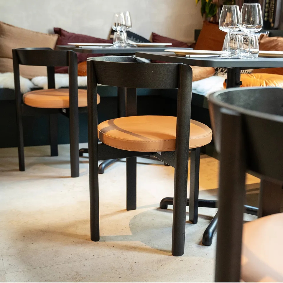 Scandinavian leather dining chairs, moon shape, oak frames, glasses & cutlery.