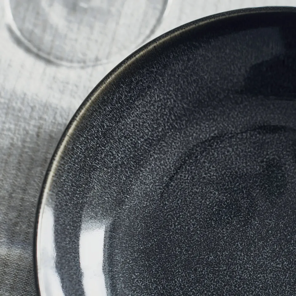 Glossy plate on dark fabric.