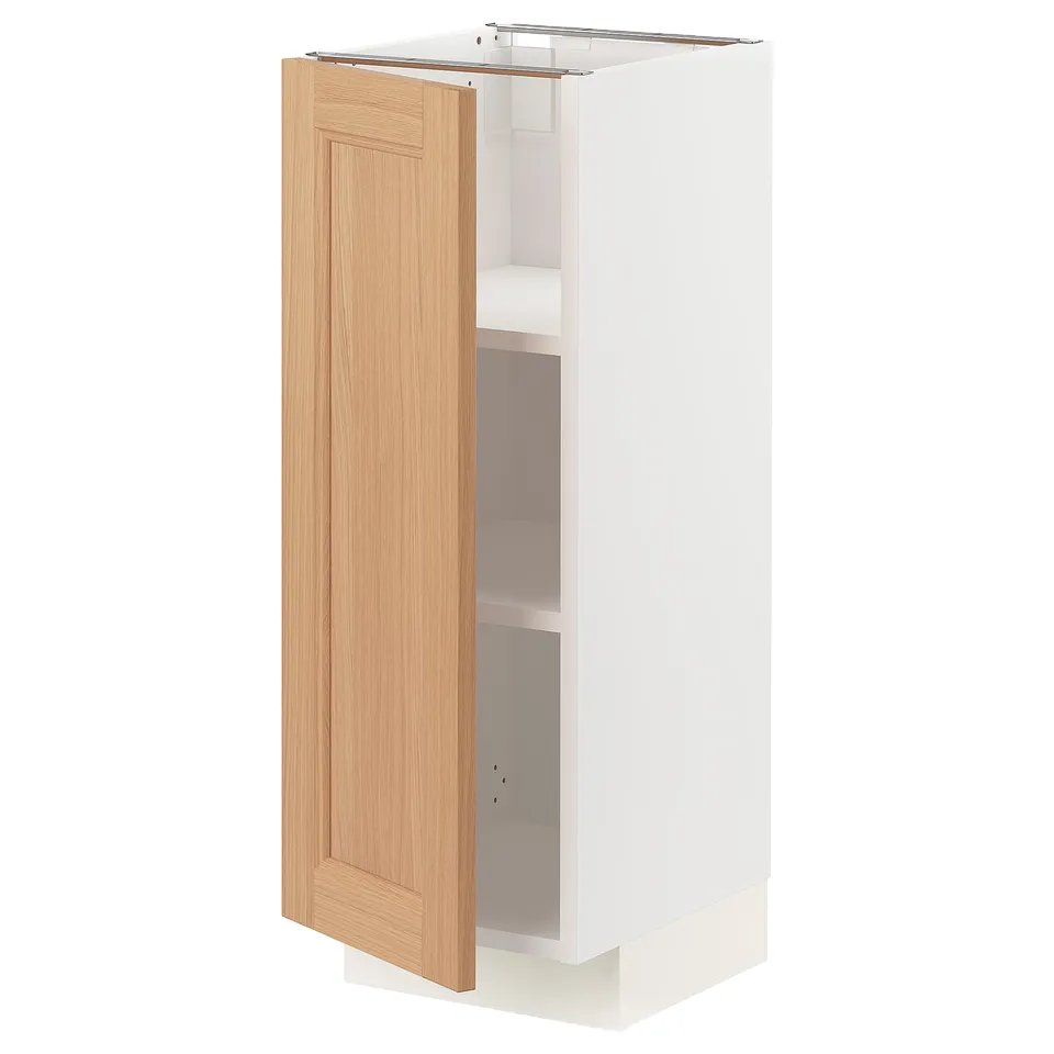White METOD kitchen cabinet with oak door open, displaying shelves.