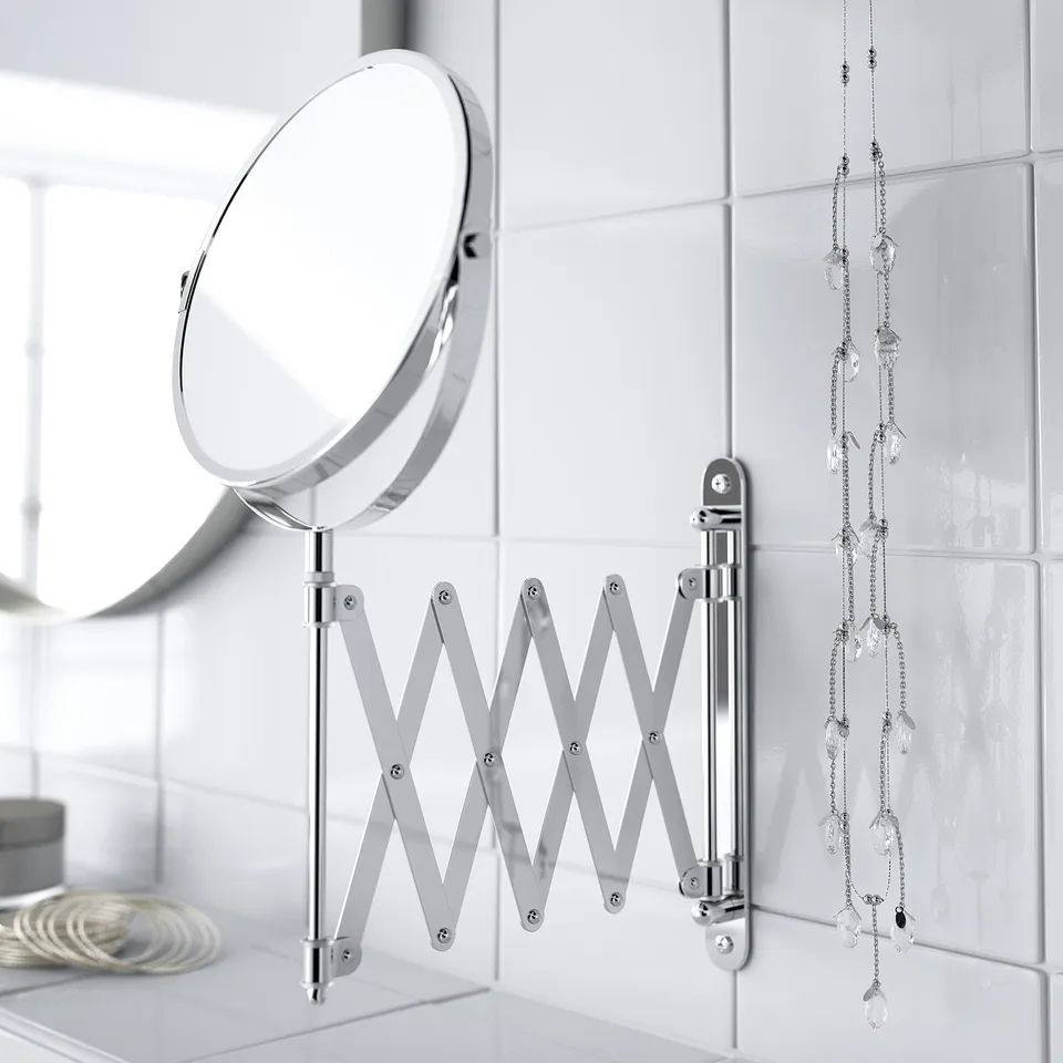 Magnifying mirror on wall, angles adjustable. Ideal for shaving, makeup, and hair styling. Water-resistant for bathroom use.