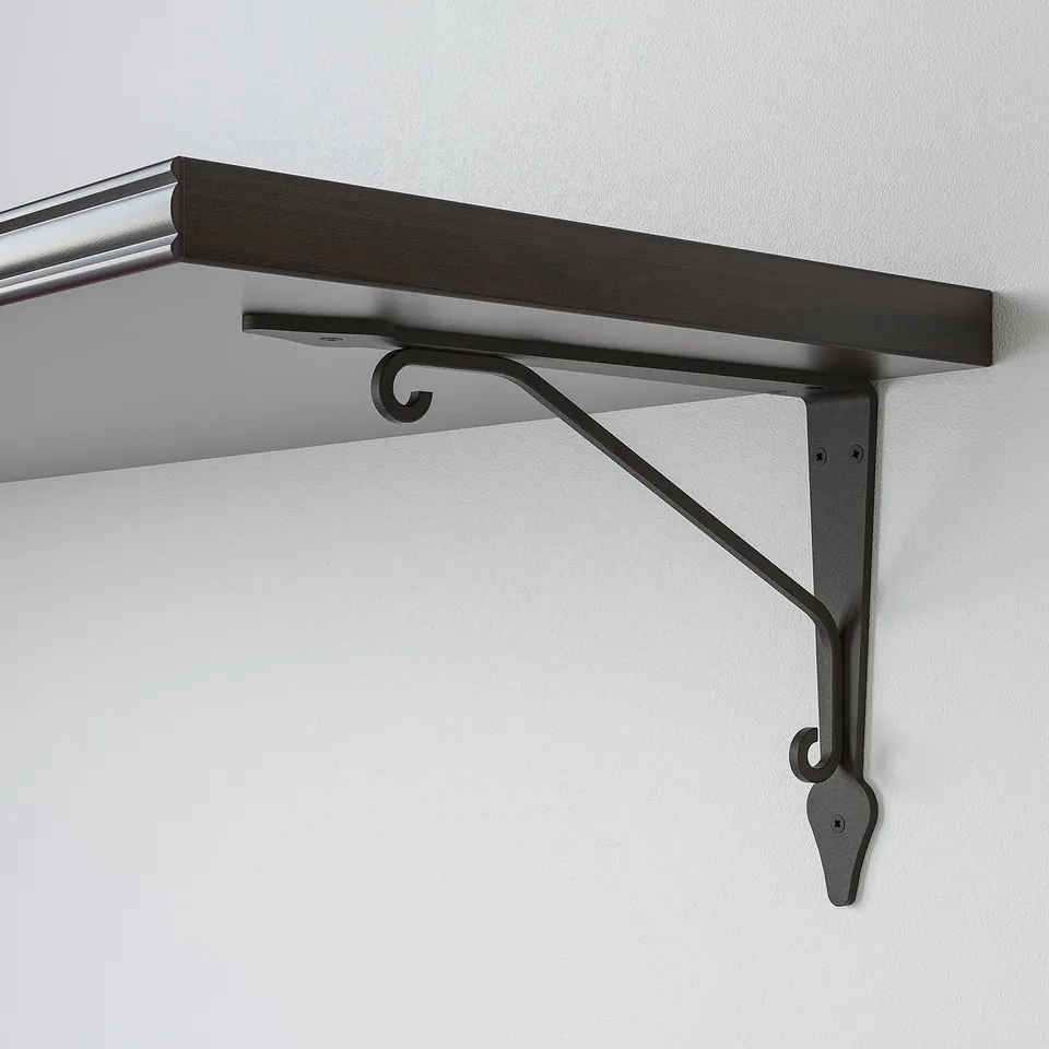 Wooden shelf mounted on wall with sturdy black metal bracket. Elegant bevelled edge on one side.