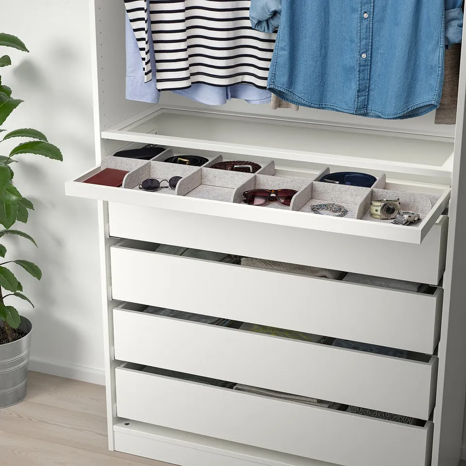 White wardrobe with pull-out tray storing glasses and accessories, ensuring organised and accessible storage in a closet.