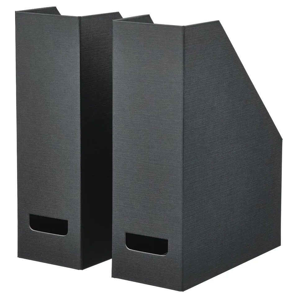 Two grey vertical magazine holders standing side by side made from recycled paperboard, featuring cut-out handles at the top end for easy access.
