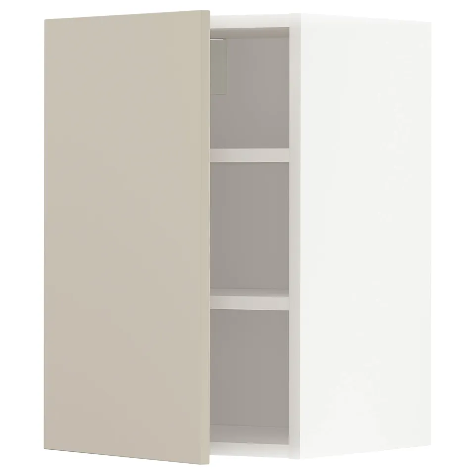 A beige METOD kitchen cabinet with one door open, revealing adjustable shelves inside.