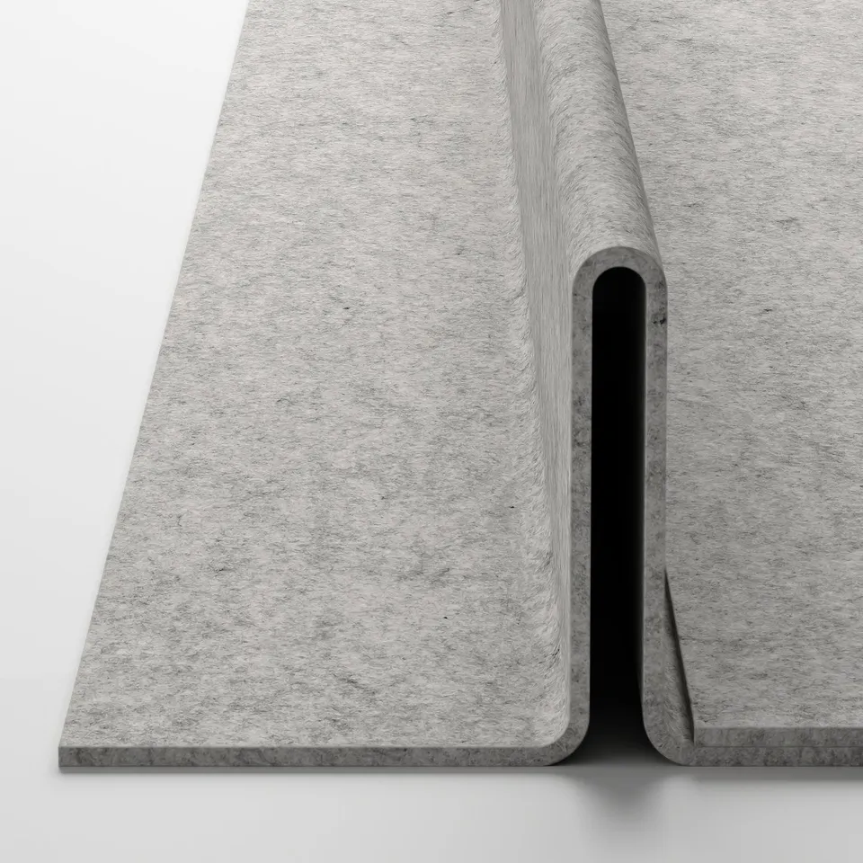 Flat, grey fabric shoe insert with slightly raised edges, placed on white surface.