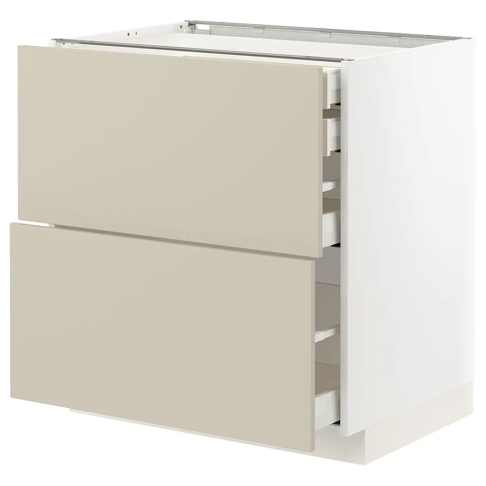 A beige METOD kitchen cabinet with two open drawers, displaying its organised interior. The cabinet is rectangular with a smooth, modern design.