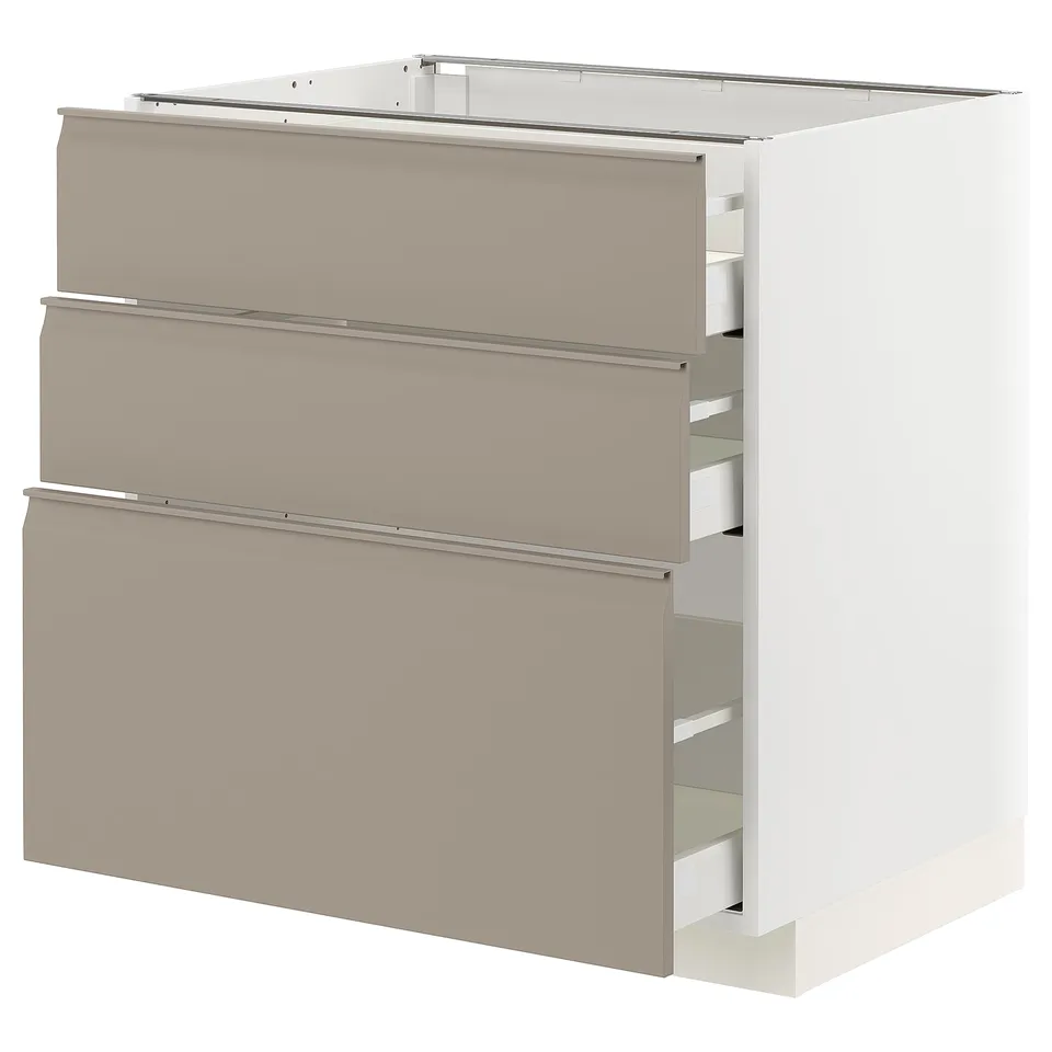 A modern METOD kitchen cabinet with three storage drawers in matte grey-beige. The cabinet is rectangular with integrated handles and a sleek design.