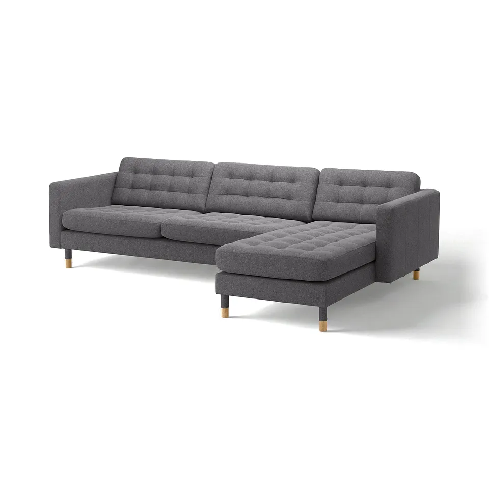 Modern grey sectional sofa with tufted cushions, wooden legs, and angled chaise lounge.