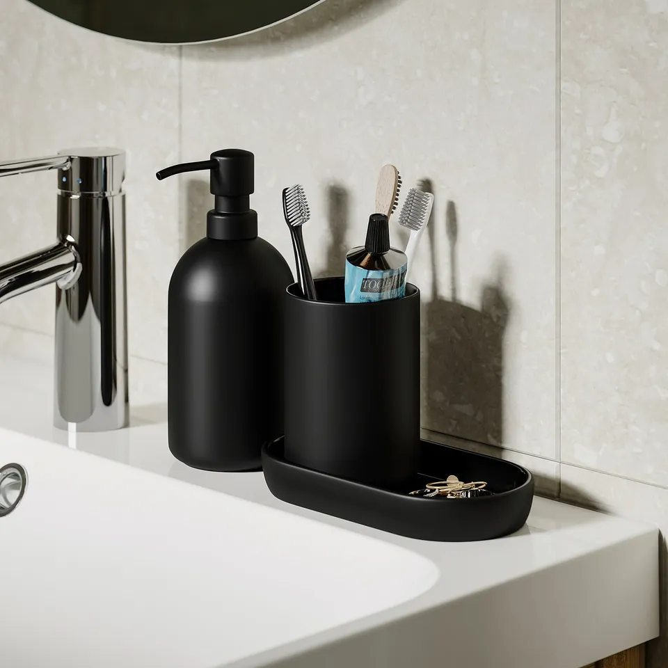 Modern bathroom set with soap dispenser, toothbrush holder, and tray organised on sink. Black matte glass offers a sleek look and easy functionality.