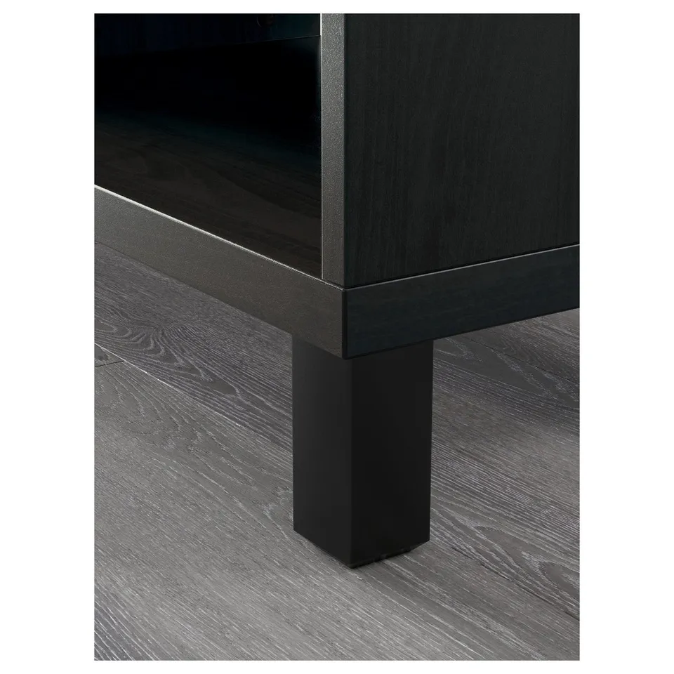 Black tv stand with wooden legs and adjustable shelves.
